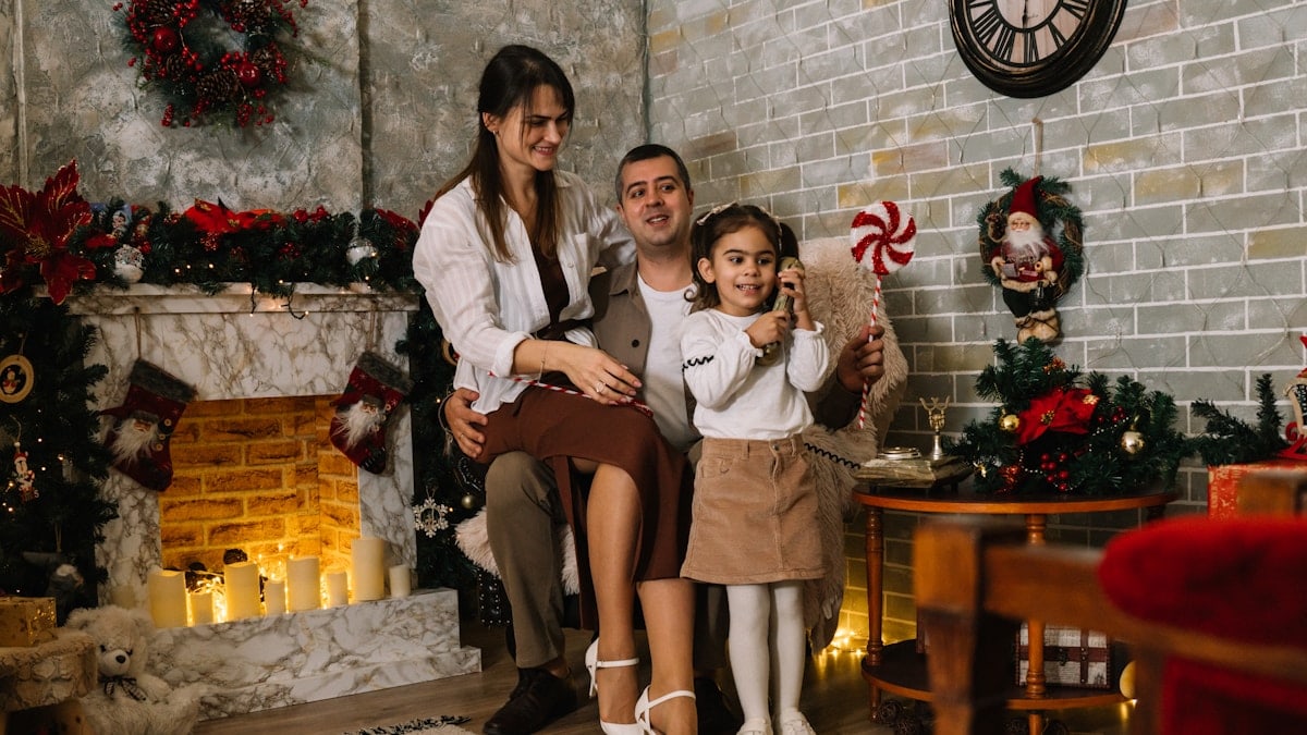 A family is posing for a picture in front of a christmas tree